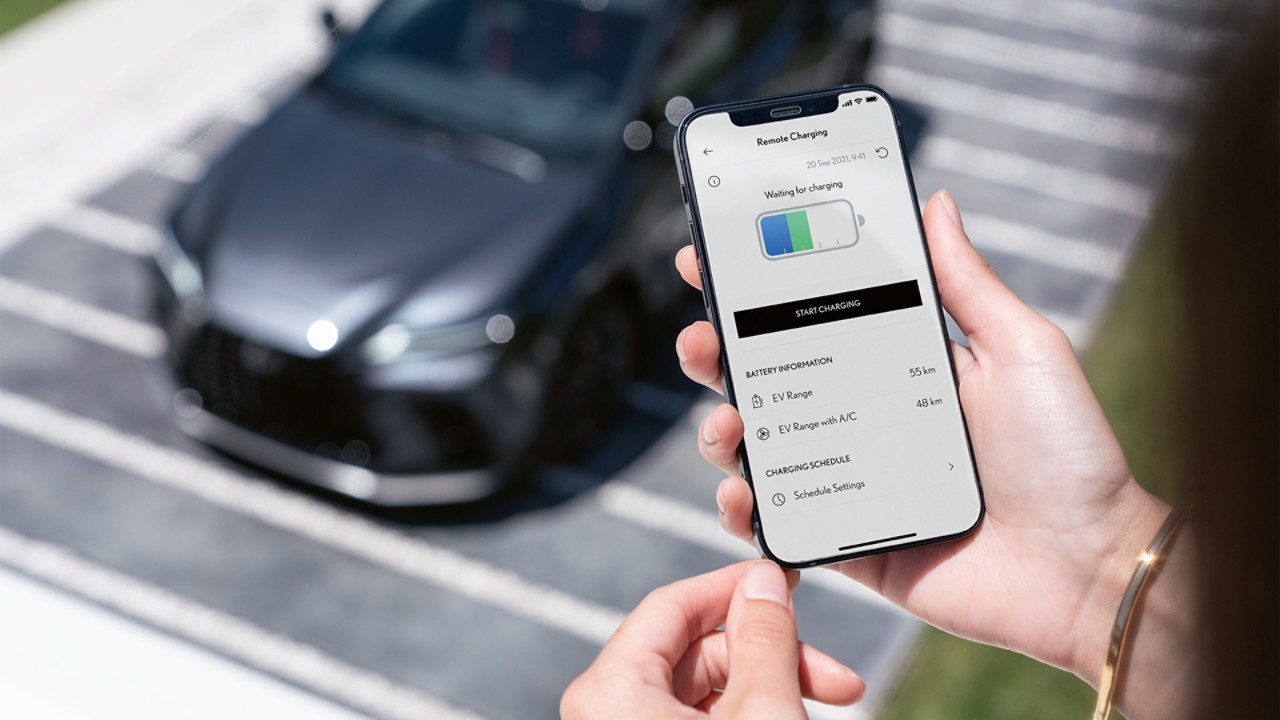 A man using his mobile phone to access the Lexus Link app