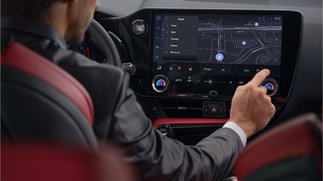 A man using a Lexus NX's multimedia screen