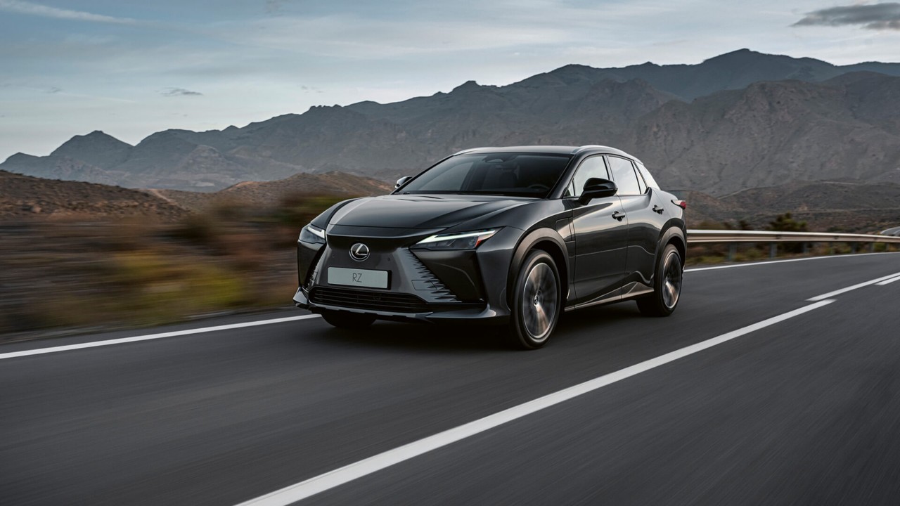 Side view of the Lexus RZ driving in a rural environment 