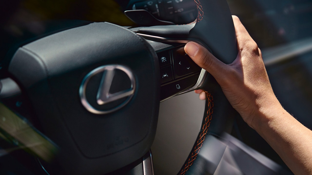 A hand on Lexus steering wheel